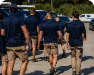 Plumbers walking to their service vans on a Gladesville job